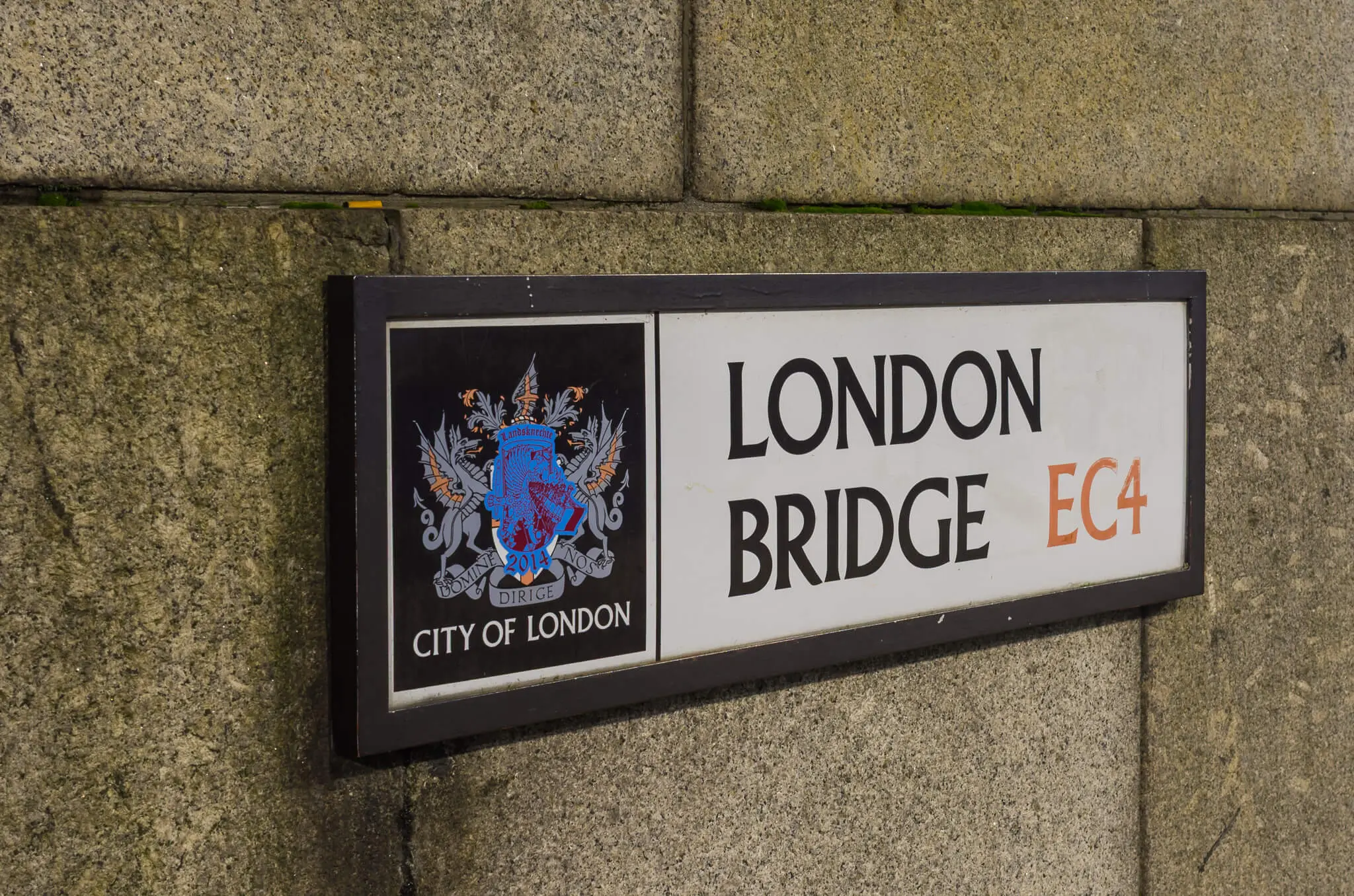 London Bridge EC4 street sign in the City of London mounted on a stone wall